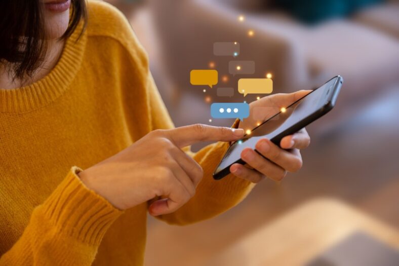 Young woman using smartphone for chat and communication