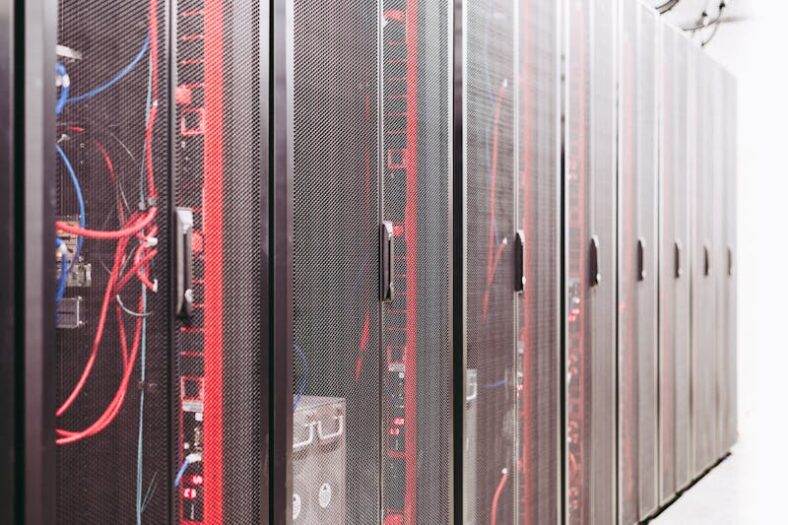 Modern data server room with network racks and cables.