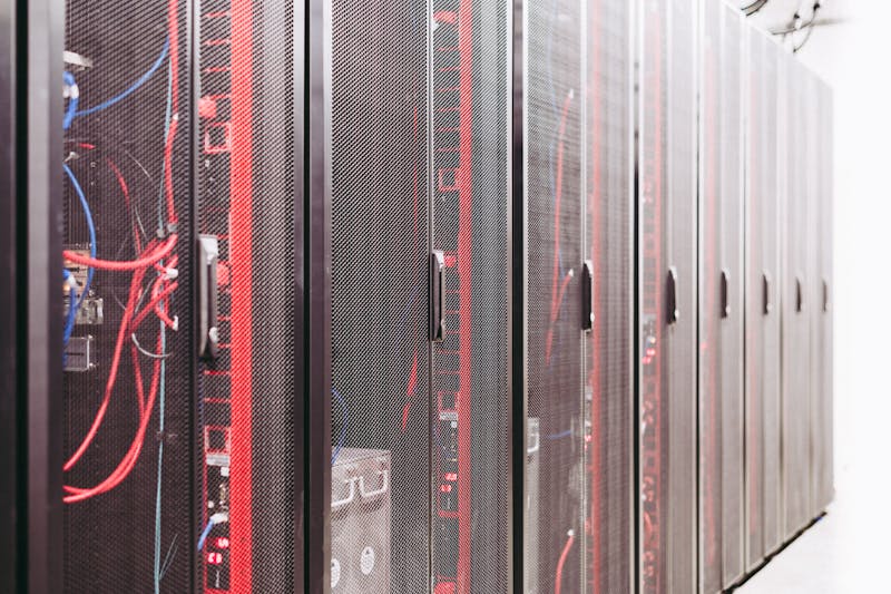 Modern data server room with network racks and cables.